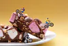 A staged photographic print of mini figures mountain biking on rocky road by New Zealand artist Adam Popovic, available at The Little Gallery Tairua